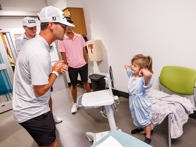 Children's of Mississippi patient Hazel Gray of Biloxi got a surprise visit from professional golfers Philip Knowles, right, Matt McCarty and Hunter Logan.