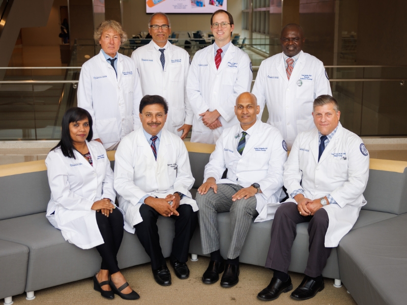 The Department of Radiation Oncology including, standing, Dr. Robert Allbright, assistant professor; Dr. Eswara Mundra, assistant professor and resident program director; Dr. Neil Duggar, associate professor; Dr. Paul Mobit, associate professor; seated, Dr. Roselin Nittala, assistant professor; Dr. Rojymon Jacob, chair; Dr. Prashant Yarlgadda, clinical instructor and Dr. Douglas Calvin, assistant professor, poses for group photo.