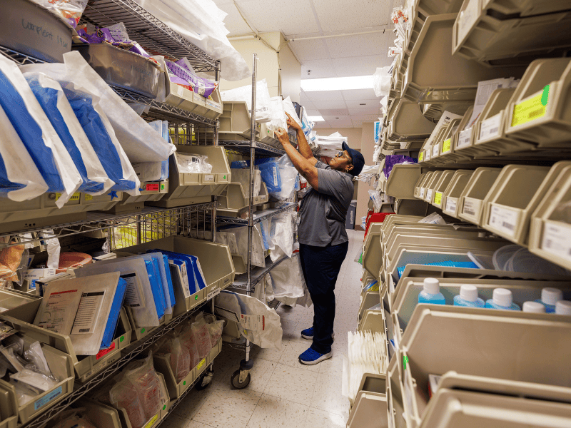 Supply tech Vicky Bulley replenishes supplies for the medical intensive care unit. Scales on bins alert her team when supplies need to be restocked.