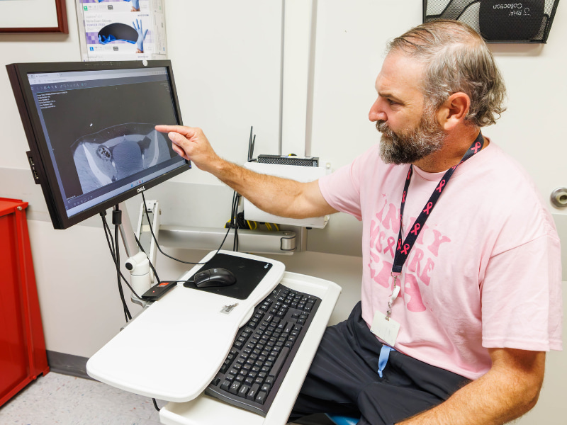 Dr. Benjamin McIntyre, professor of surgery and breast cancer reconstruction specialist, reviews images from a patient's CT scan.