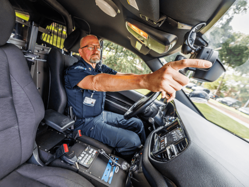 UMMC Police and Public Safety Department Training Sergeant James Seeberg adjusts the new camera installed in his vehicle.