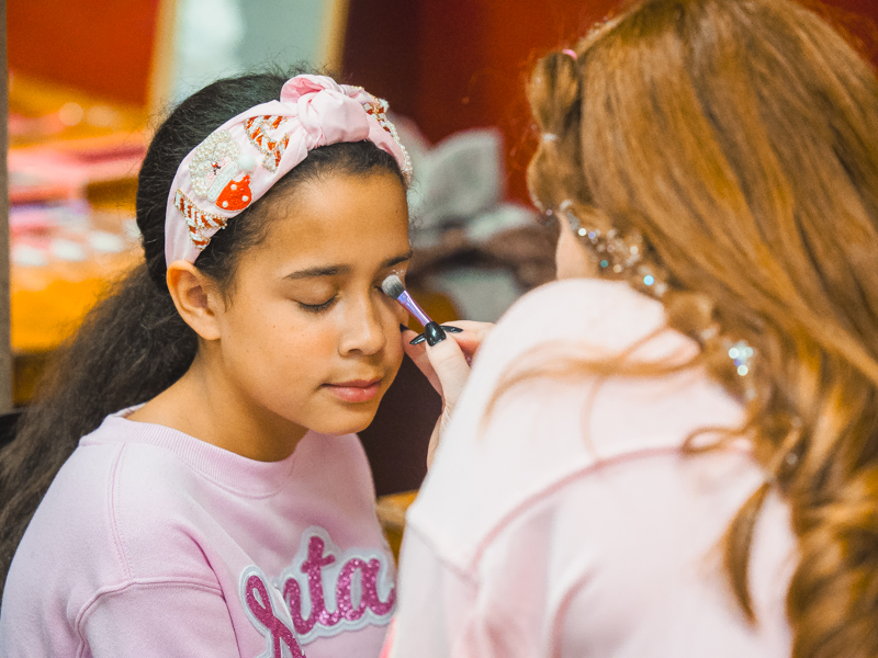 Katie Rose Guilfoyle closes her eyes for makeup application in preparation for the Welcome to New York! Tween Fashion Show at Mistletoe Marketplace.