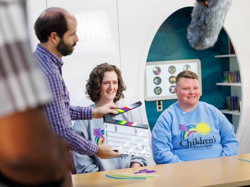 Win Graham, media production supervisor, readies hospital school teachers Bridget Regan, left, and Haley Ainsworth for a video take.