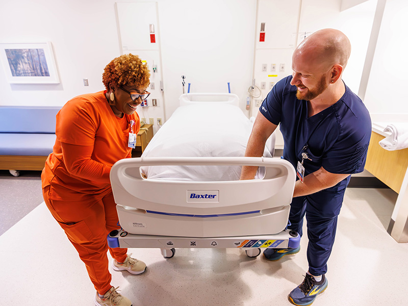 Nurse Managers Carla Hickmon-Scott and Jonathan VanLandingham prepare one of the rooms for patients on the sixth floor of the Conerly Critical Care Tower.