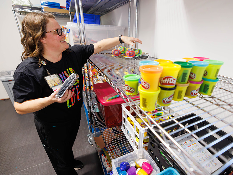 Child Life Specialist Ashley Prendez adds donated items to their supply closet.