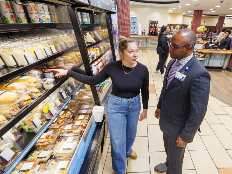 Christina Diretto, Aramark regional marketing manager, talks with George Pressley about the healthy grab-and-go options that will be available when Aramark begins food service at UMMC Feb. 1.