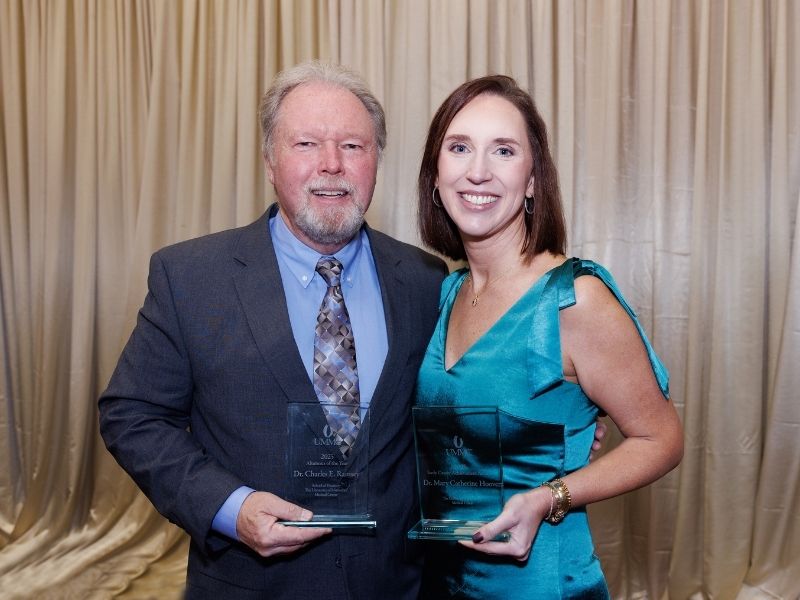 Dr. Charles Ramsey, Dental Alumnus of the Year, and Dr. Mary Catherine Hoover, recipient of the Early Career Achievement Award, smile after the 2025 School of Dentistry Alumni Awards ceremony.