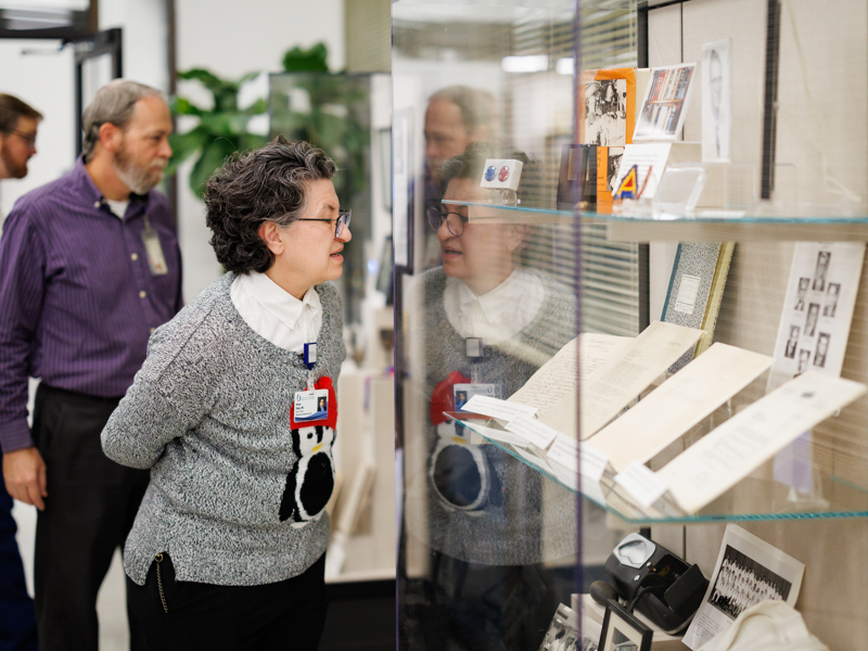 Dr. Norma Ojeda, chair of advanced biomedical education, examines a display case during a museum preview held for members of the Academy for Excellence in Education in December.