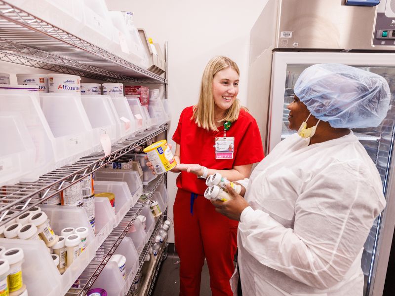 Registered dietitian Mary Chosen Caples, left, talks with Milk Lab technician LaToya Spann.