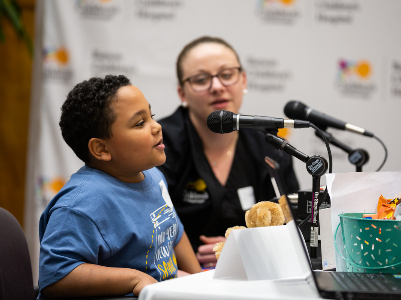 Deuce Bloodsaw tells his story on live radio as mom Dr. Nikki Cowan, director of Children’s of Mississippi’s medical-surgical and inpatient psychiatric units, looks on in this photo from 2020. Joe Ellis/ UMMC Communications