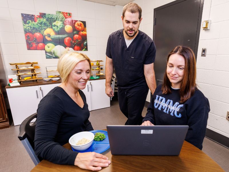 Discussing a care plan with are cancer care team members, from left, Rebecca Turner, registered dietitian, Tommy Berg, exercise physiologist, and Melissa Wood family nurse practitioner.