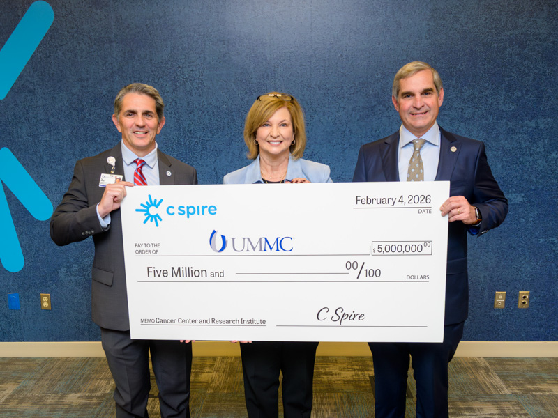 Displaying C Spire's $5 million gift to the UMMC Cancer Center and Research Institute are, from left, Dr. Rod Rocconi, Ergon Chair for Cancer Research and CCRI director; Dr. LouAnn Woodward, vice chancellor for health affairs; and Dr. Holt Crews, assistant professor of obstetrics and gynecology and a member of the C Spire board of directors.