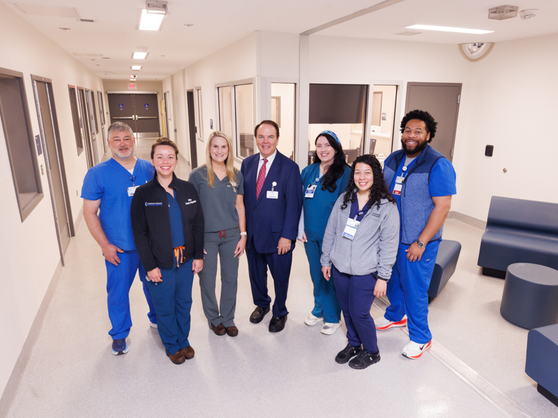 The psychiatric emergency services unit is a multidisciplinary collaboration between the Department of Psychiatry and Human Behavior and the Department of Emergency Medicine. Pictured above are members of the care team, from left; Michael Eldridge, RN; Ashley Lawrence, Adult ER Nurse Manager; Sherry Riser, director of nursing; Dr. Mark Ladner, chair of the Department of Psychiatry and Human Behavior; Dr. Ruby Hall, psychiatry resident; Courtney Moody, ER technician and Johnathan Bell, RN.