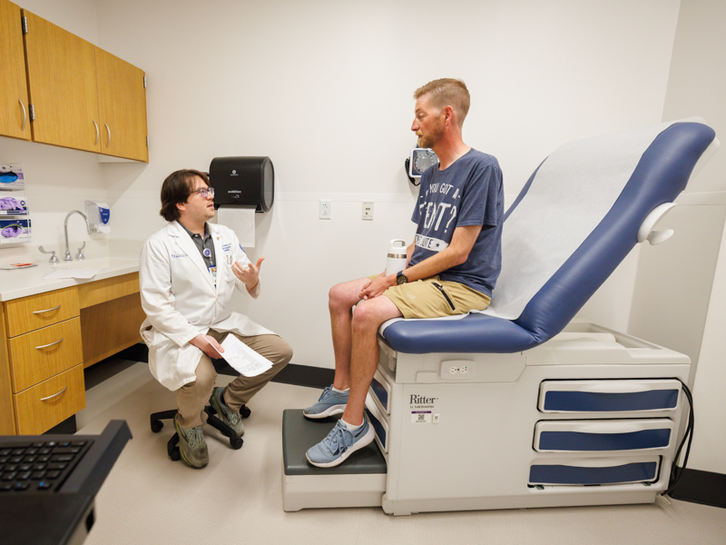 Dr. Thomas Skelton Jr., an adult cardiologist at UMMC, examines Barth syndrome patient Jordan McDade during a multidisciplinary clinic visit, where specialists collaborate to develop a coordinated, personalized care plan.