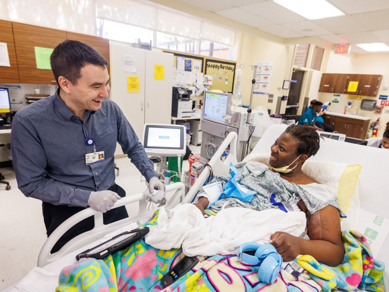Dr. Tim Yen, assistant professor of medicine and nephrologist,  takes measurements of April Harris of Jackson during her hospital visit. Yen's research aims to develop safer, more personalized approaches to managing fluid levels during dialysis.