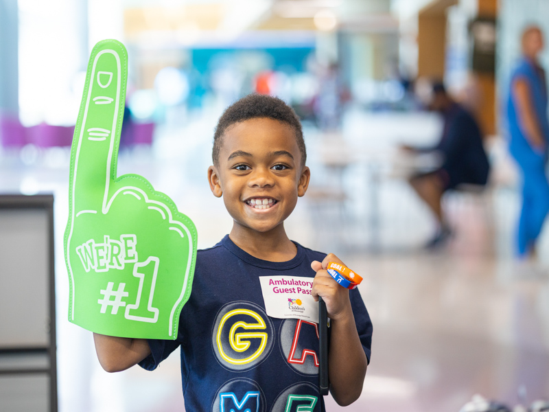 Noah Dodson, 8, of Byram poses with his new foam finger at Tailgating with Friends.