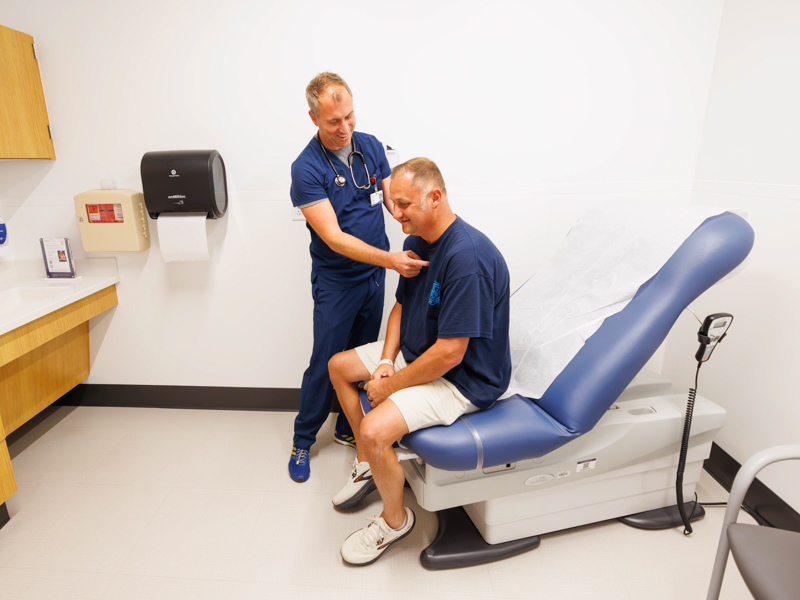 Dr. William Campbell examines patient Steven Wood during a follow-up visit at Colony Park North