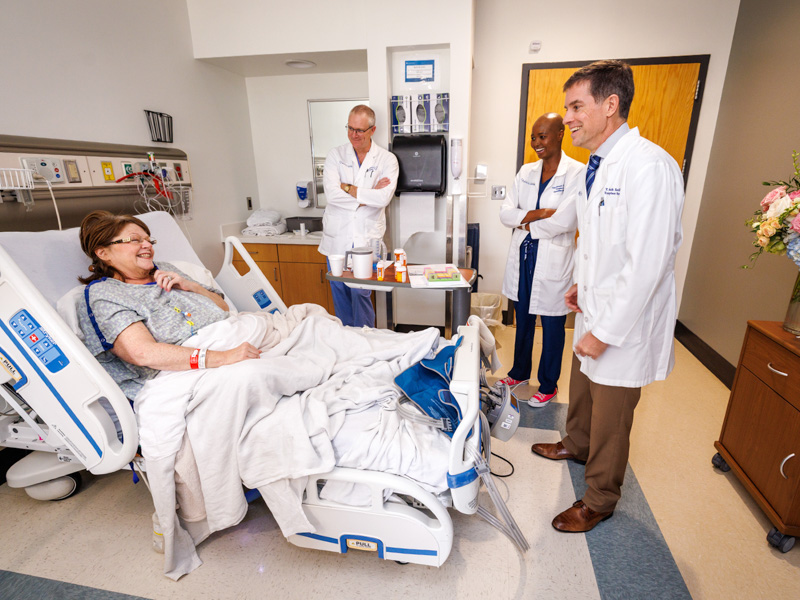 Ashley Castle shares a laugh with her transplant team, from left, Dr. Chris Anderson, Dr. Praise Matemavi and Dr. Mark Earl.