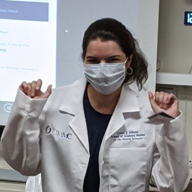 Student shows her excitement about getting her white coat.