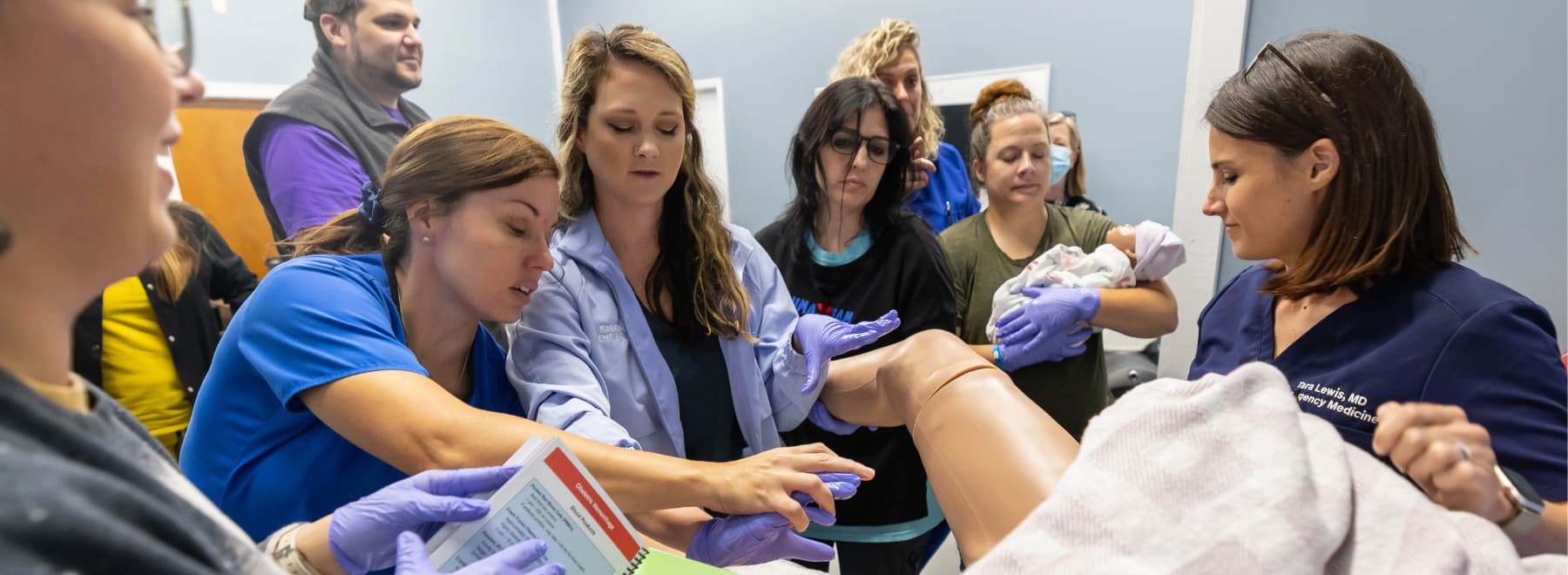 From left, From left, Lackey Memorial registered nurse Hayden Neal, UMMC's Dr. Rachael Morris, Lackey Memorial nurse practitioner Kacey Jones, Lackey Memorial registered nurse Kristen Robinson and UMMC's Dr. Tara Lewis use a high-tech simulator mother to practice delivery of the placenta following childbirth.