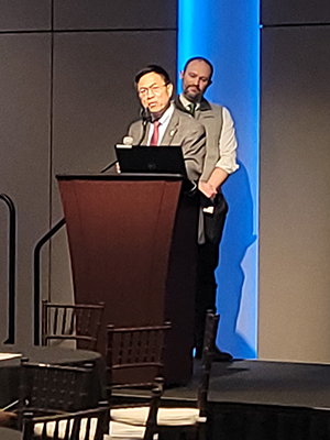 Dr. Lei Zhang speaks while Dr. Matt Kutcher looks on.