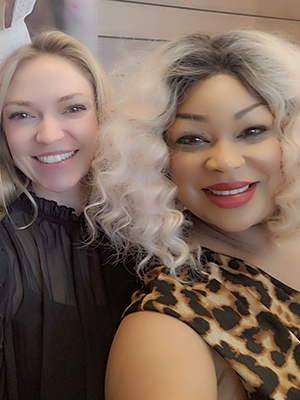 Michelle Brassfield (right) take a picture with a conference attendee.