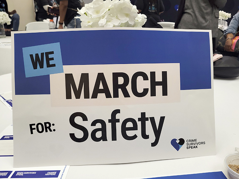 Table sign reading We March for Safety.