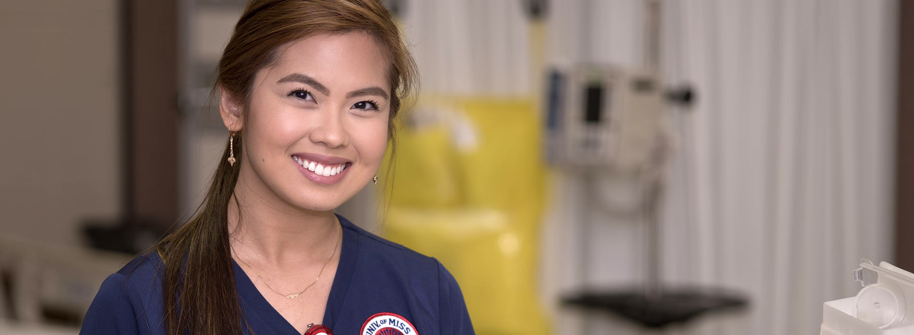 Smiling woman in nursing scrubs