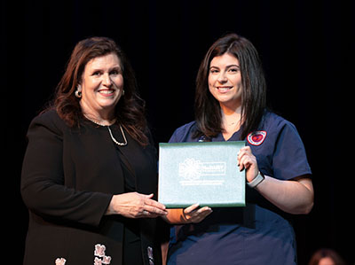 DAISY nursing student award given to Abigail Grace May from Dean Julie Sanford.