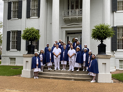 Photo of Mississippi Nurse Honor Guard members in their nursing uniforms outside of the Governor's Mansion
